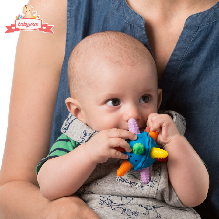 baby with teether ball in hands